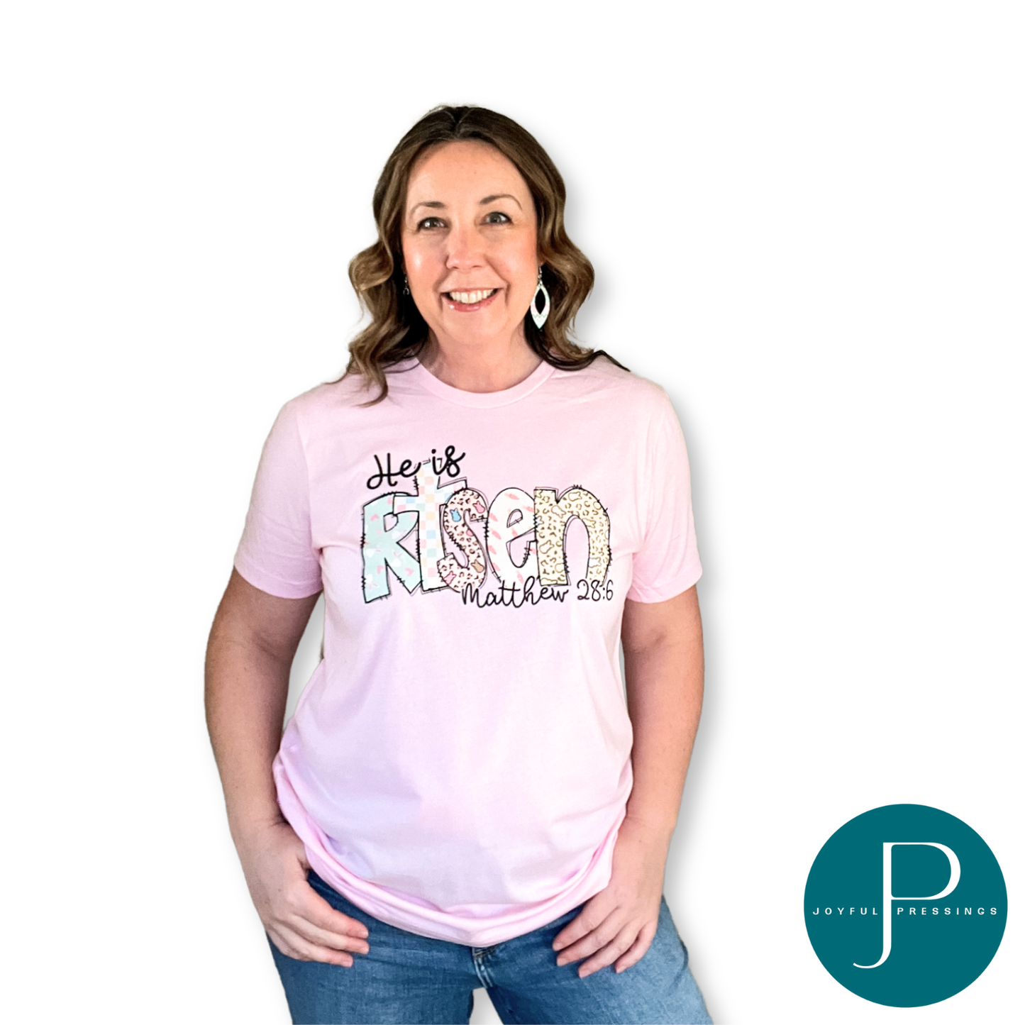 Model wearing He is Risen Easter t-shirt. Playful Easter print on a heather pink tee.