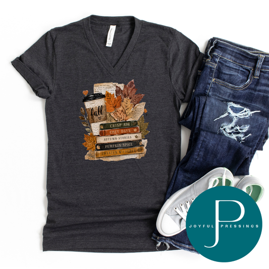 Dark grey heather Bella + Canvas v-neck tee with a fall book stack graphic, styled flat with dark wash jeans and white sneakers