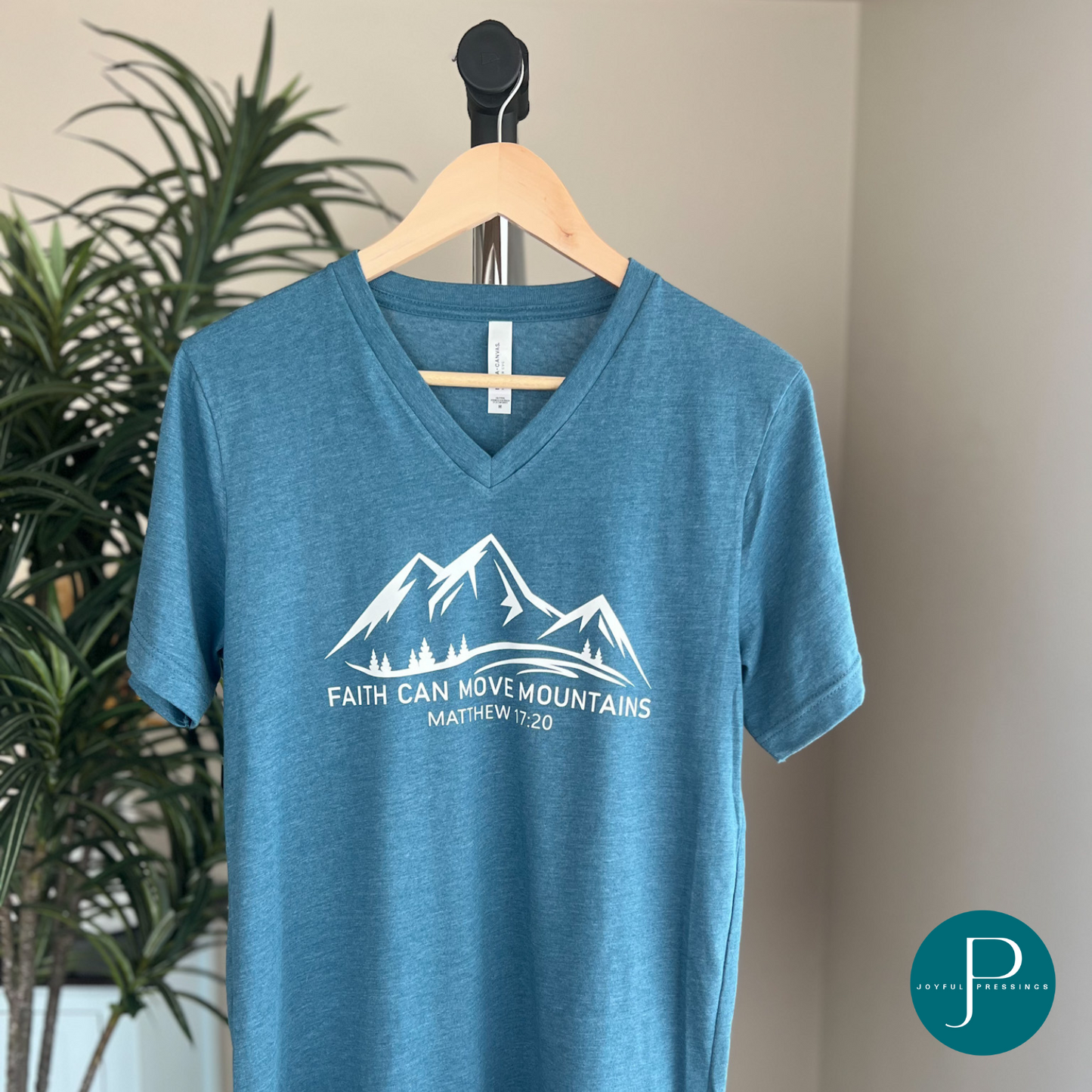 faith can move mountains print on a deep teal t-shirt