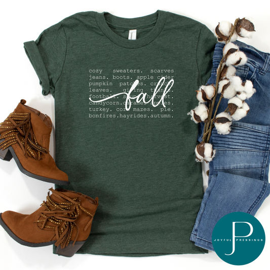 Fall print on a forest green tee.  Displayed in a flatlay with jean and brown boots.