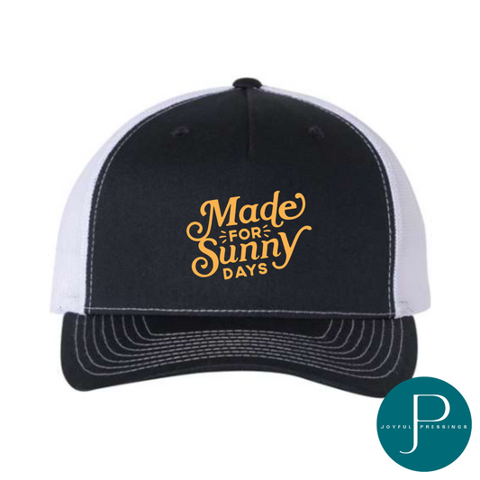 Navy and white Richardson trucker hat with the phrase "Made for Sunny Days" in yellow lettering on the front.