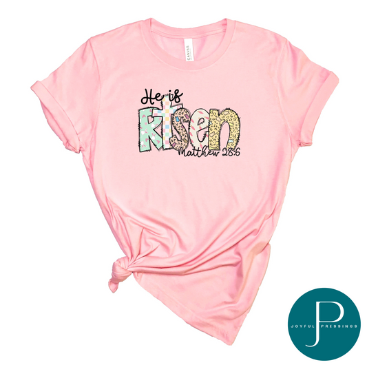 mockup of He is Risen Easter t-shirt.  Playful Easter print on a heather pink tee.