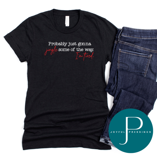 Black heather Bella + Canvas t-shirt with red and white text that reads “Probably just gonna jingle some of the way. I’m tired.”
