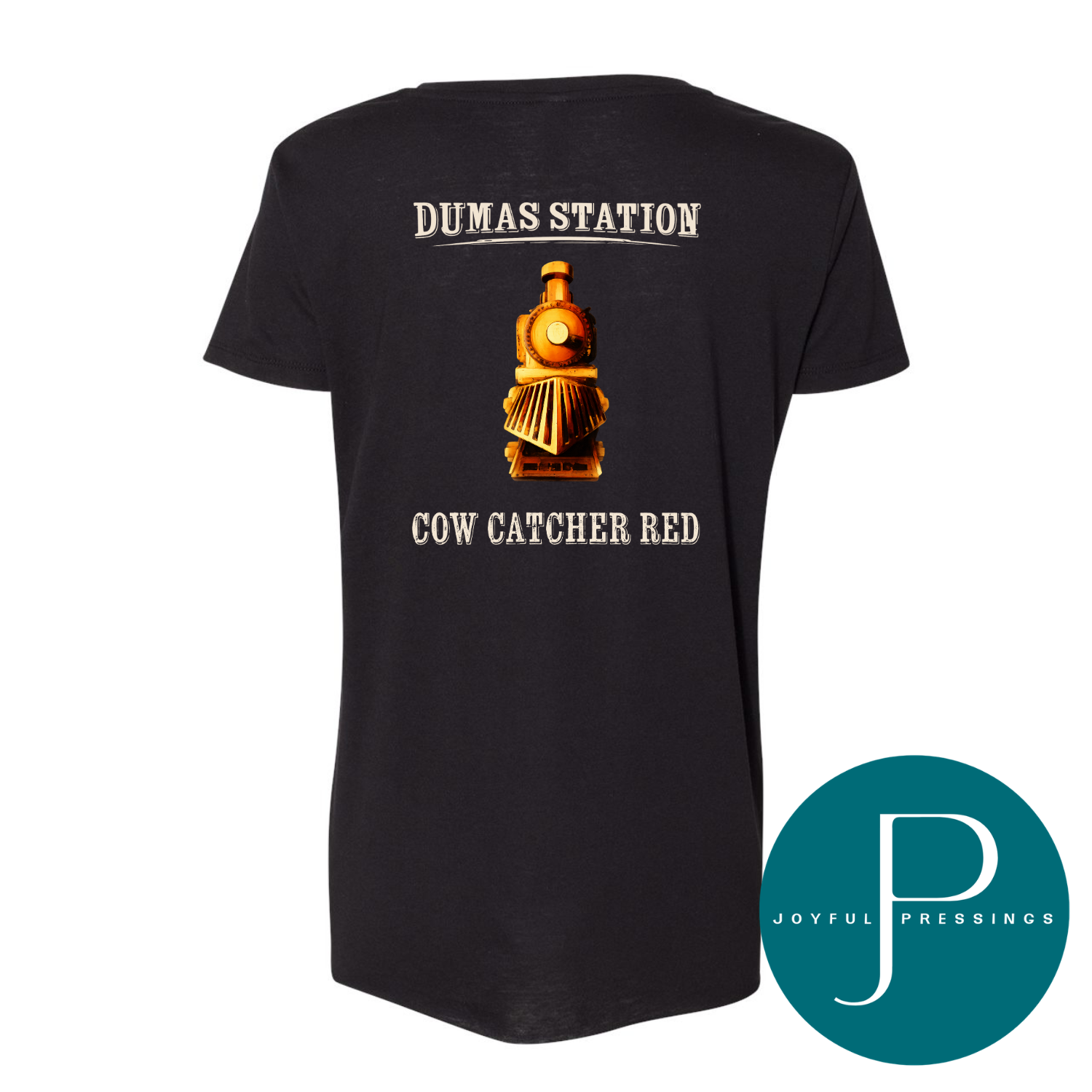 A black short-sleeve t-shirt shown from the back, featuring a graphic of a golden train with the text 'DUMAS STATION' above and 'COW CATCHER RED' below. A teal circular 'JOYFUL PRESSINGS' logo is in the bottom right corner.