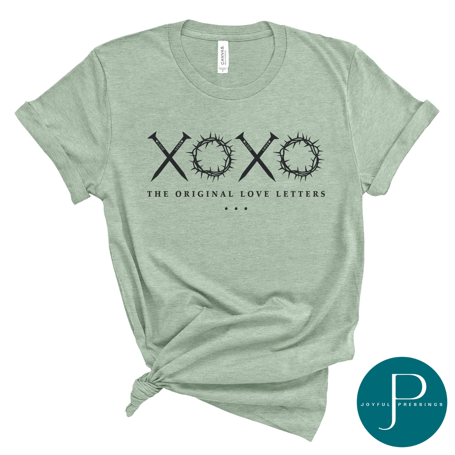 Mockup of The Original Love Letters sage green t-shirt.  Nails for the X's and crown of thorns form the O's in the XOXO print.