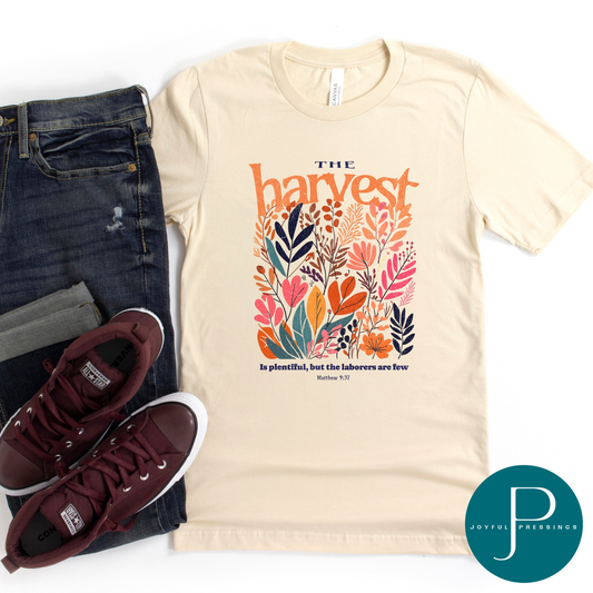 The Harvest print on a soft cream tee.  Flatlay with jeans and tennis shoes.
