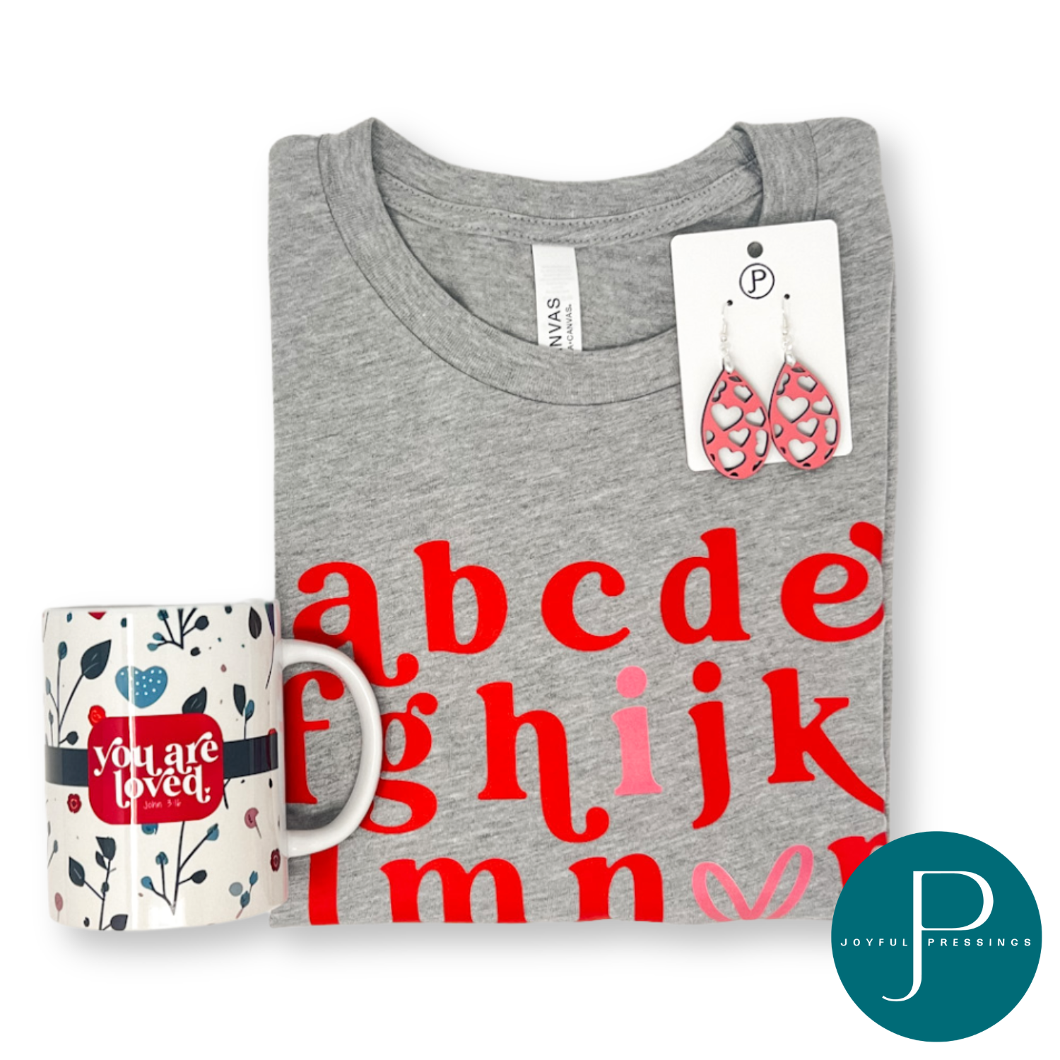 product photo of abc Valentine bundle which includes abc t-shirt, pink heart cutout earrings, and Valentine floral mug