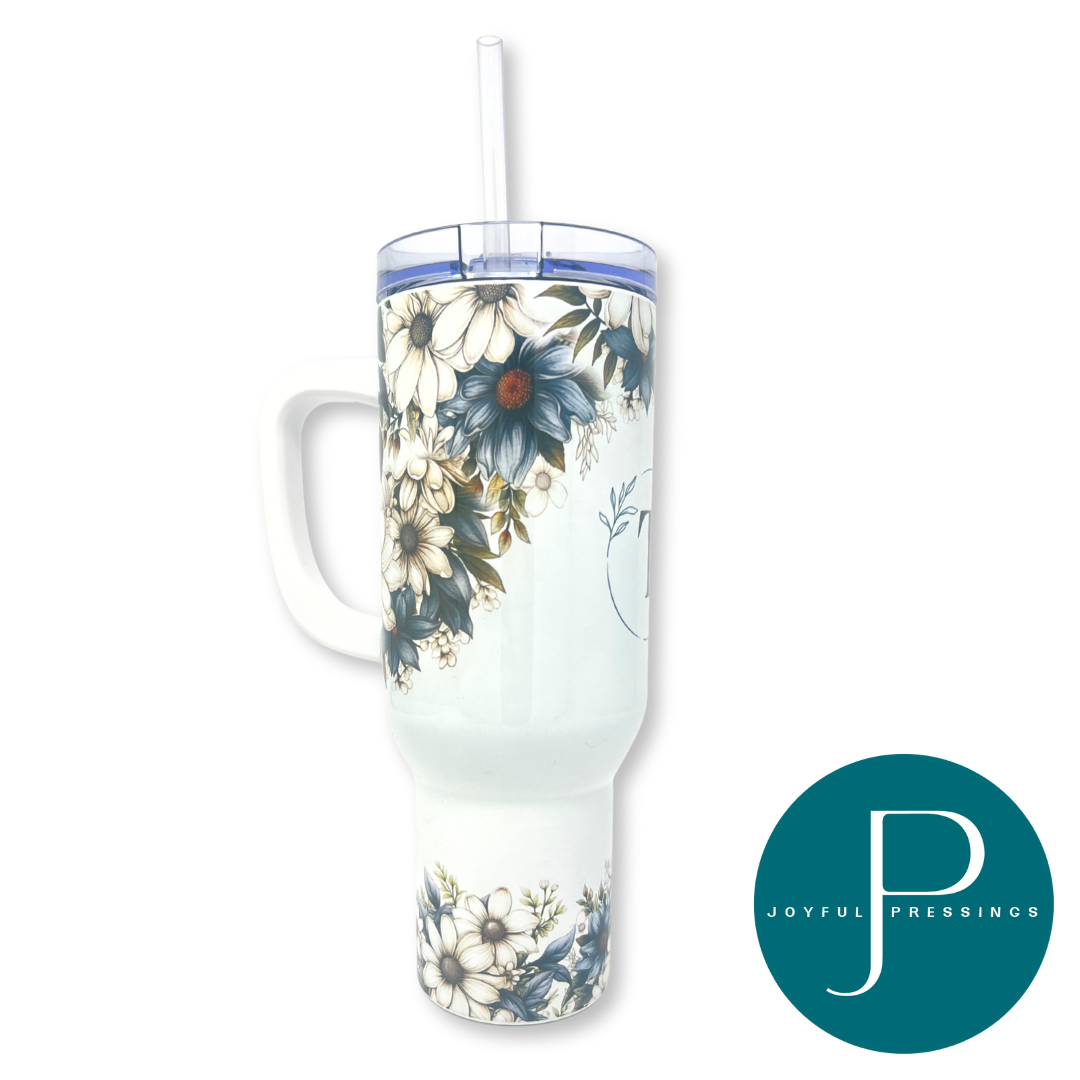 Floral-patterned tumbler with a straw on a white background, featuring the 'Joyful Pressings' brand.