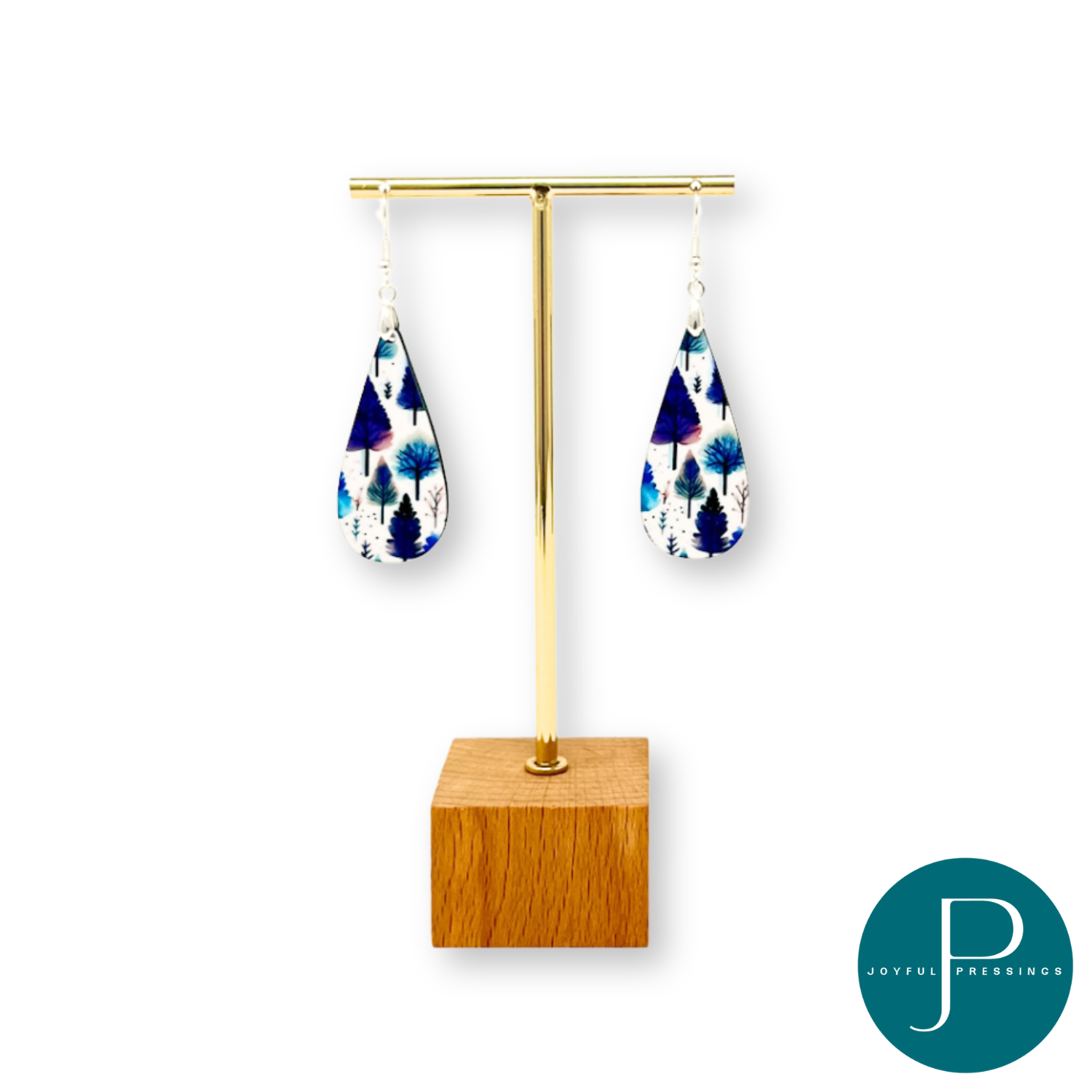 winter scene earrings displayed on stand