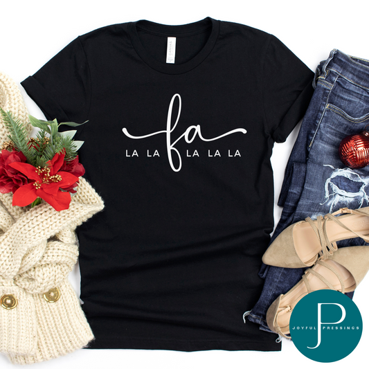 flatlay of black crew neck tee with a white print of fa LALA printed across the chest