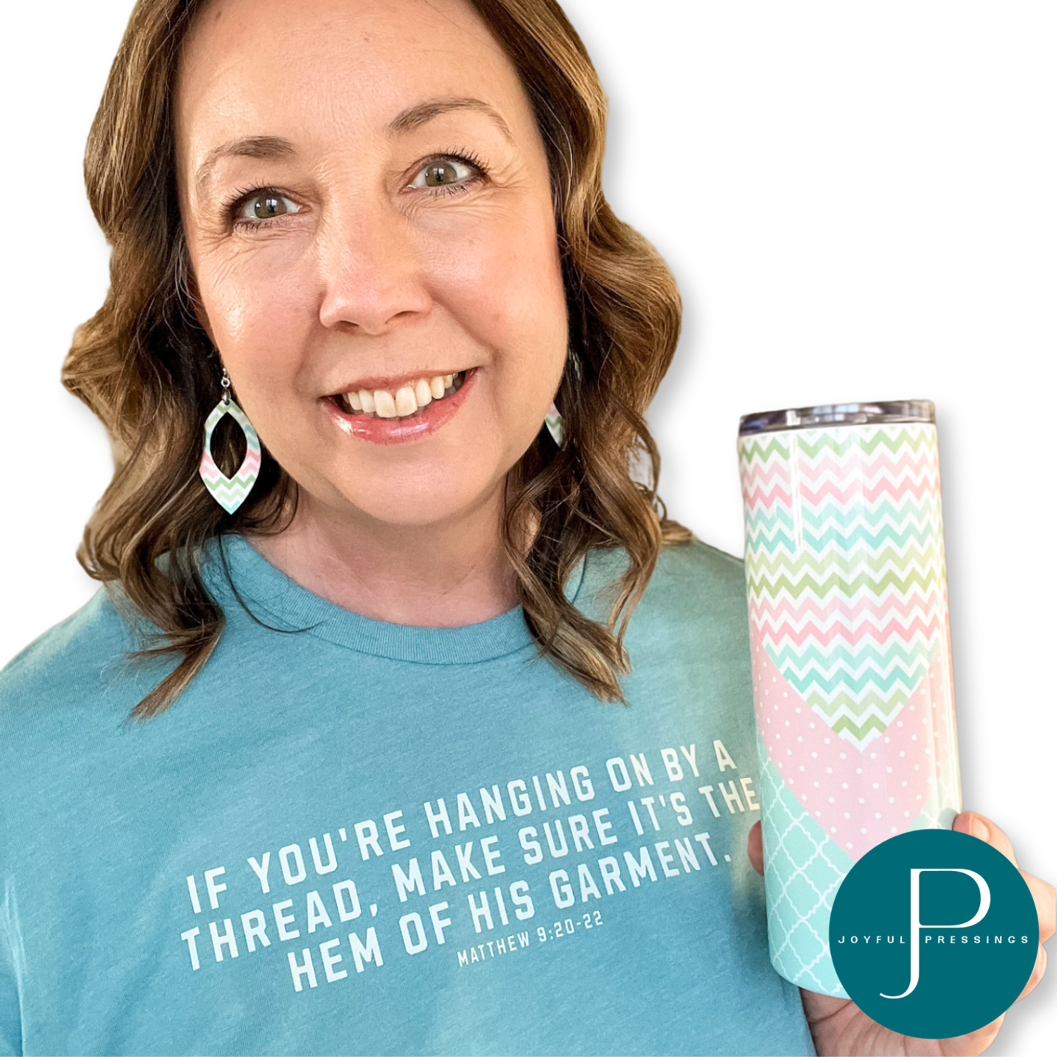 Model showcasing Hanging on By a Thread Bundle.  Includes matching t-shirt, earrings, and metal 20 oz tumbler.