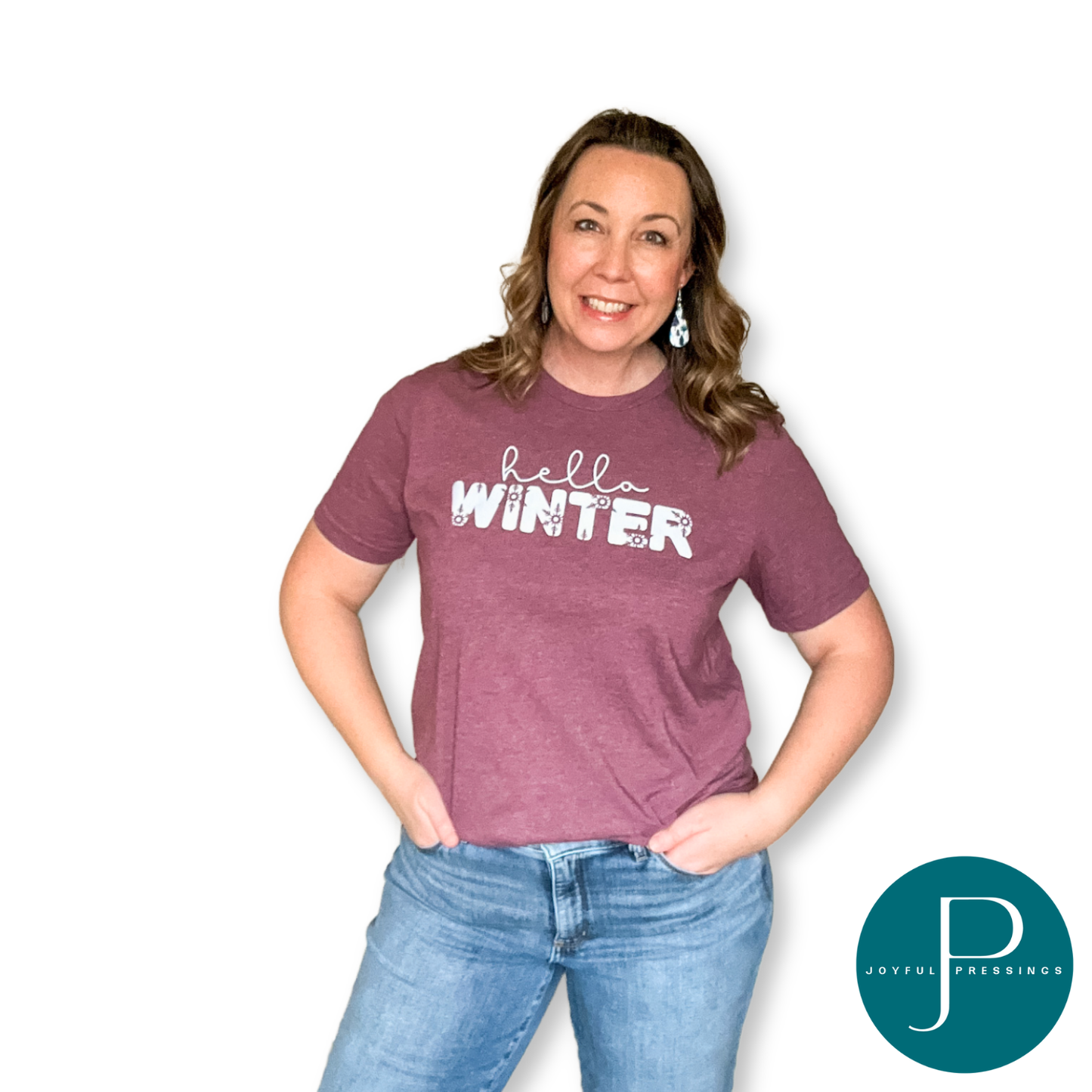 model wearing tee with a lavender graphic that says hello winter on a heather maroon tee.
