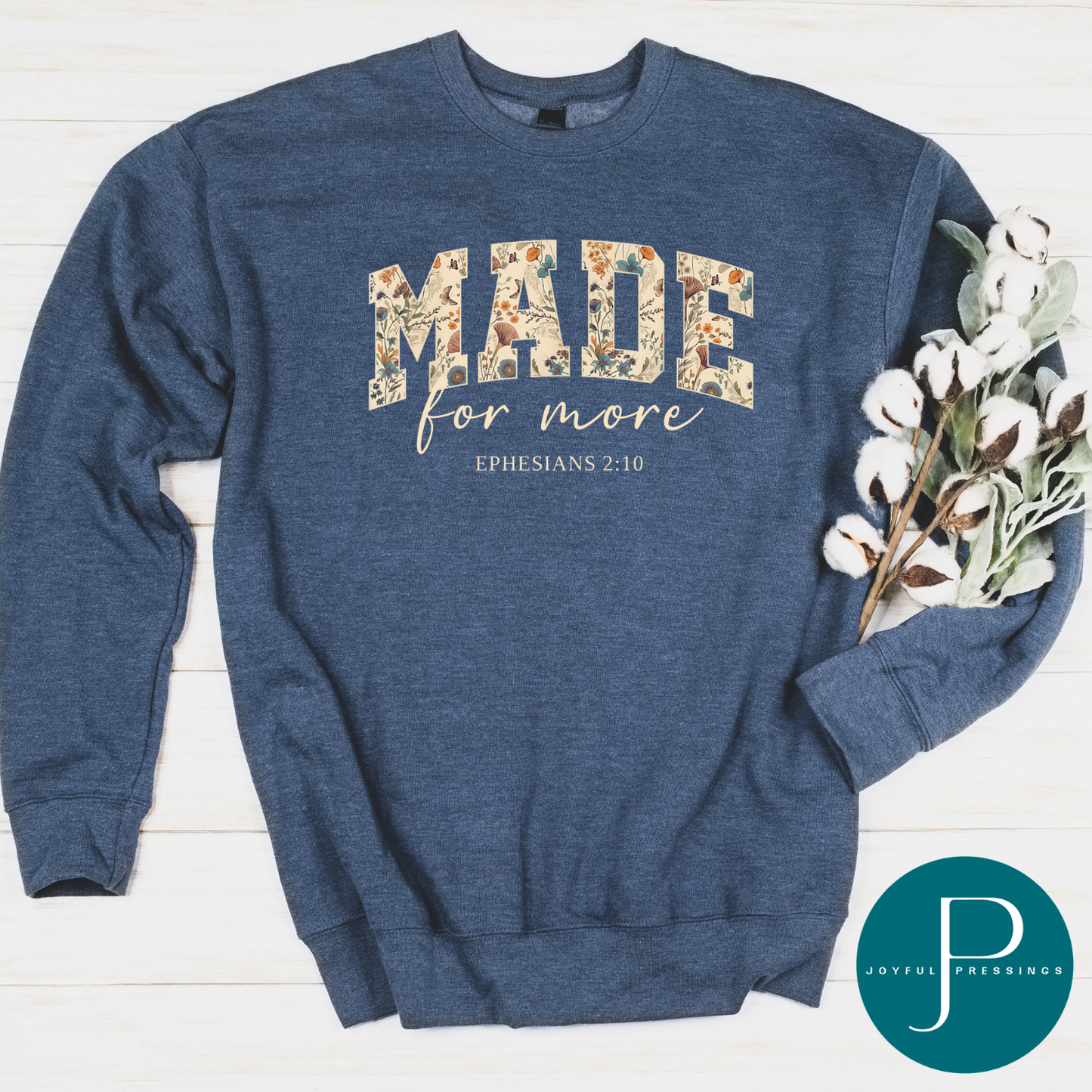 Blue sweatshirt with Made for More floral text design on a white background.