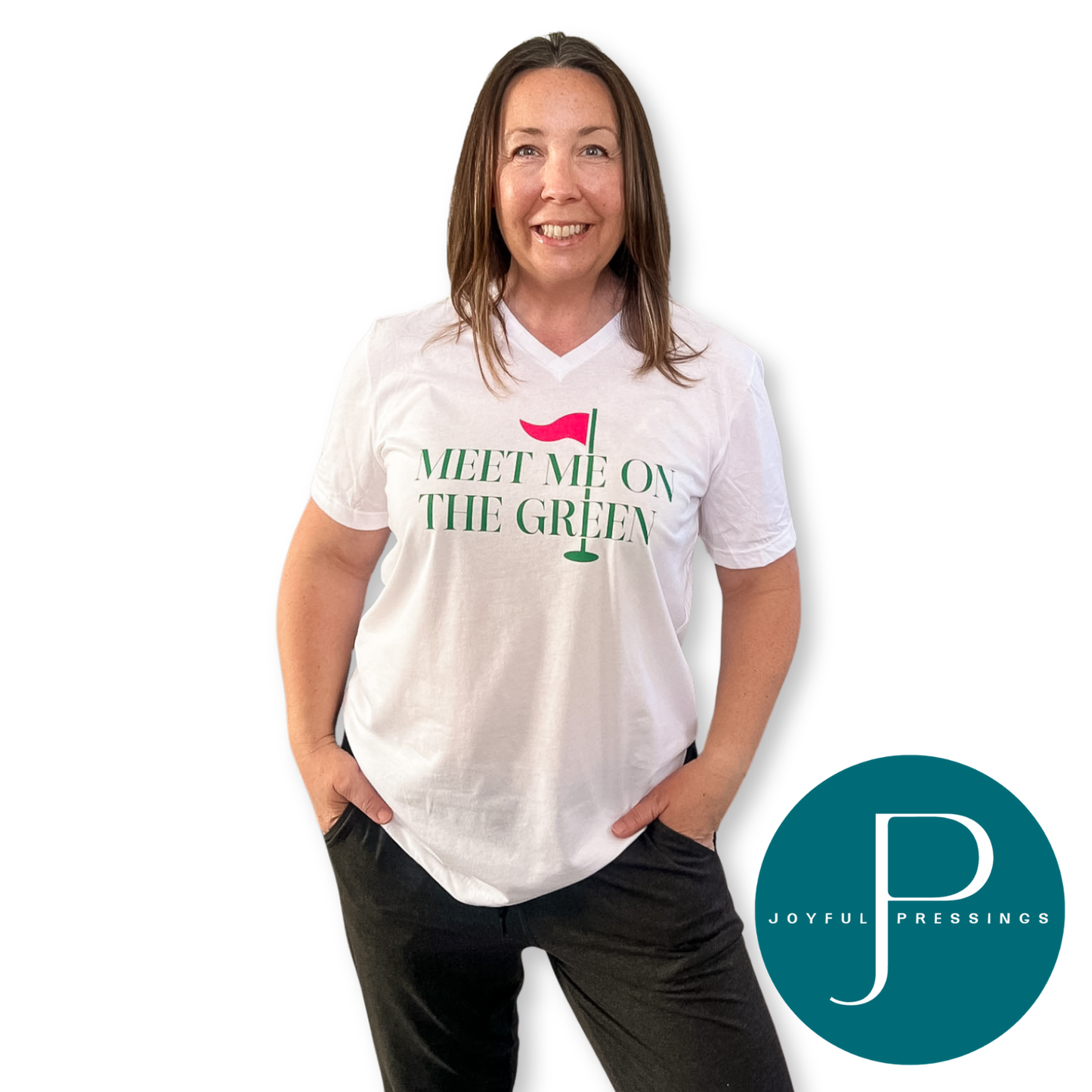 Woman wearing a white v-neck “Meet Me On the Green” golf t-shirt with black pants and Joyful Pressings logo.