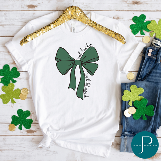 Flatlay mockup of not lucky just blessed green bow t-shirt.
