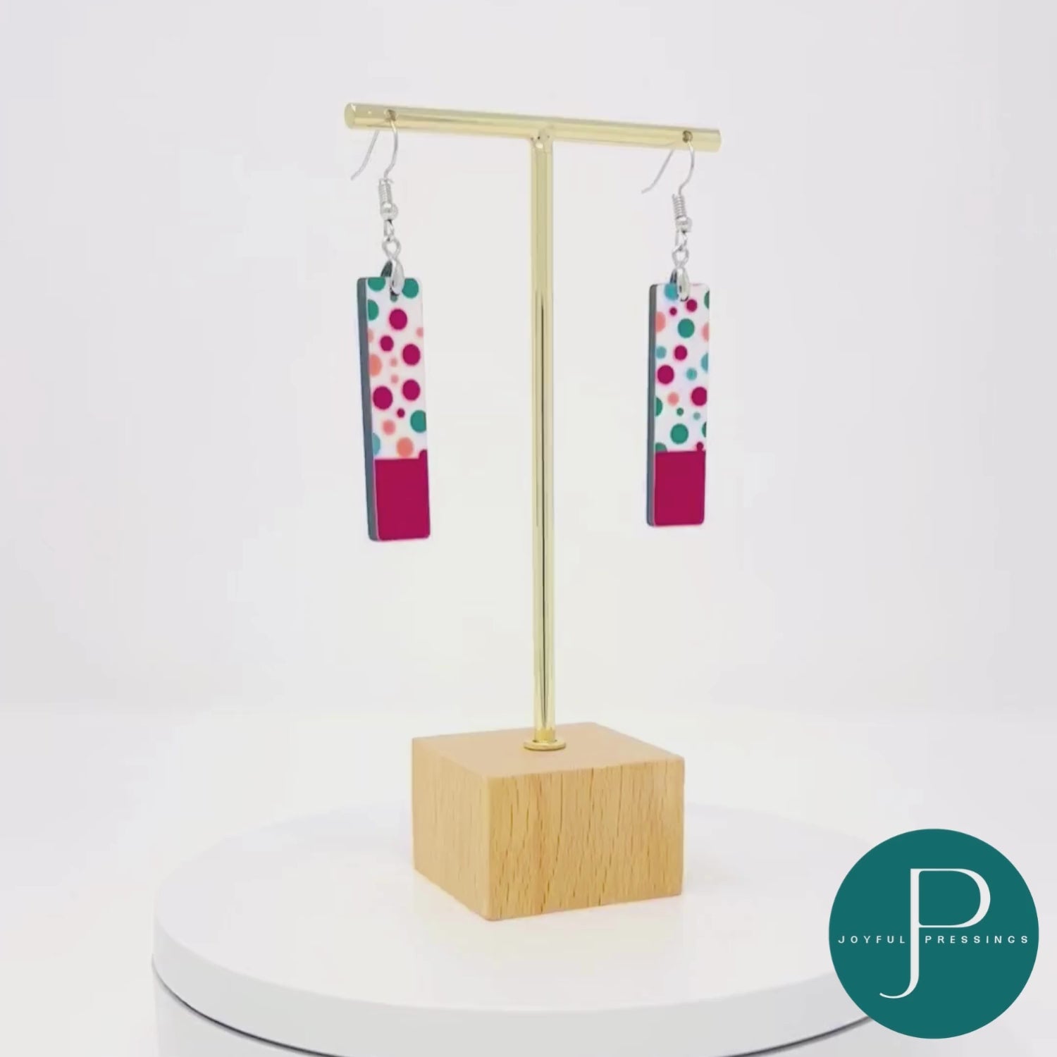 video of red polka dot earings showcased on a stand