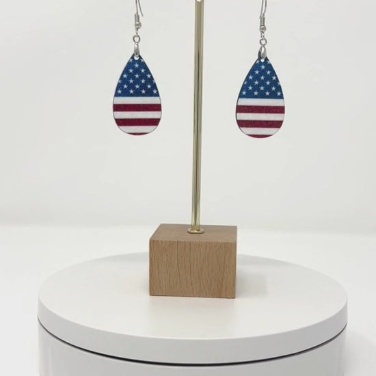 American Flag Teardrop earrings on a display circling around so you can see both sides of the earrings.