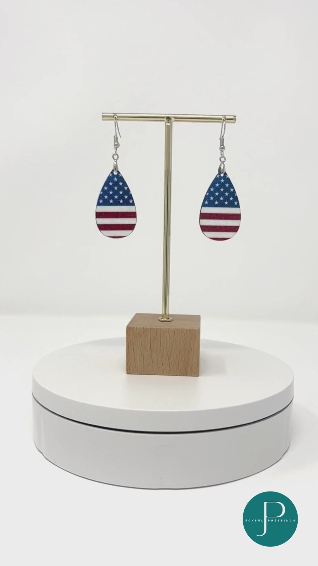 American Flag Teardrop earrings on a display circling around so you can see both sides of the earrings.