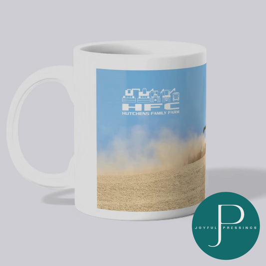 video view of a white mug with a combine cutting wheat and a white HFC logo
