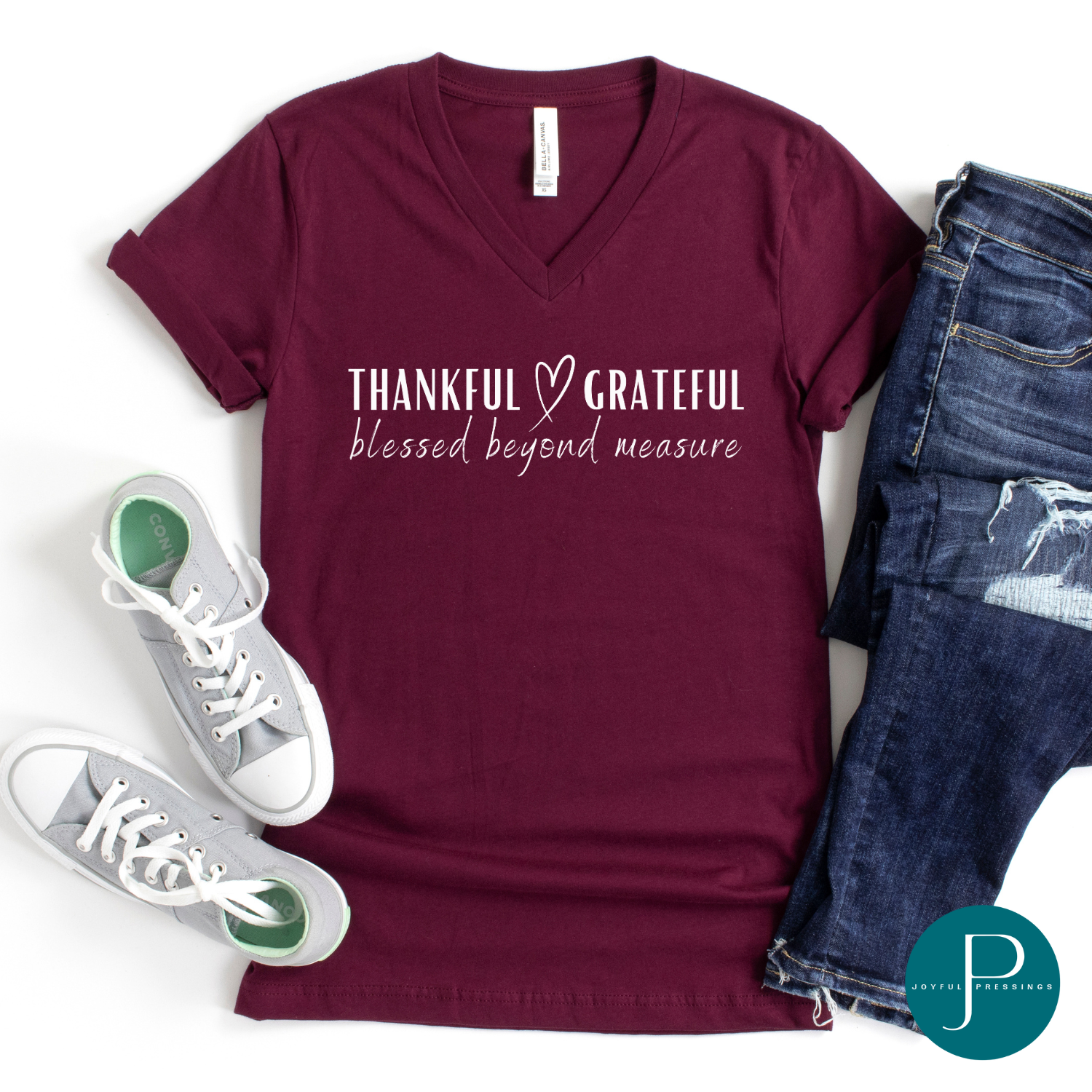 Flatlay of Thankful Grateful Blessed Beyond Measure heather cardinal colored t-shirt.