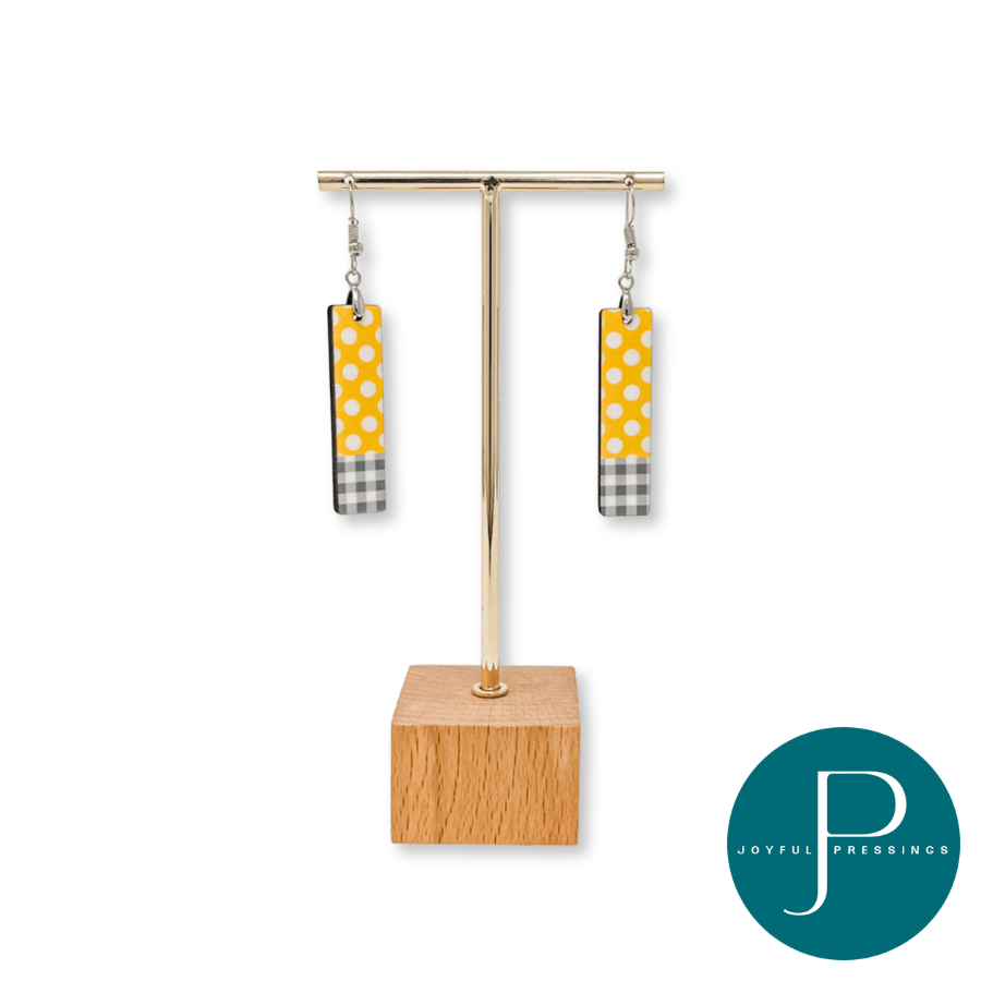 display showcasing yellow and white polka dot earrings with grey plaid.
